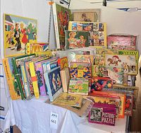 Stack of boxed vintage jigsaw puzzles including Wizard of Oz, Blondie & Dagwood, Heidi and others