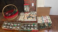 Entire lot showing ornaments boxes, string lights, basket