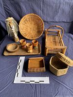 Group shot of baskets, cups, tray, bowl, bamboo stool, decorative bottle