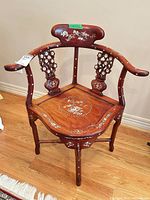 Full front view of corner armchair showing overall form and inlay details