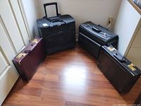 Four luggage pieces positioned together on floor