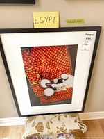 Full framed photograph print with black frame and auction tag visible