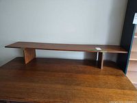 Full view of shelf resting on table surface