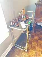 Full view of bar cart front and side with shelves and casters visible