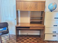 Full view of desk with hutch showing cabinet doors, shelves and keyboard tray