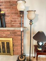 Both floor lamps beside brick fireplace showing overall design and height