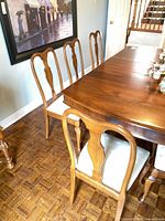Five matching Queen Anne chairs around dining table
