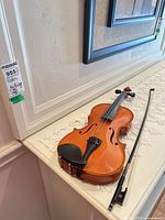 Violin and bow full view on table