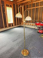 Full view of brass floor lamp showing two glass shades and overall height
