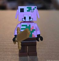 Front view of LEGO Zombie Pigman minifigure holding gold sword