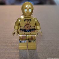 Front view of gold C-3PO minifigure showing torso and leg print