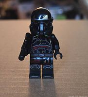 Front view of LEGO Death Trooper minifigure with helmet and blaster