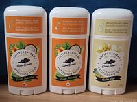 Front view of three sealed antiperspirant sticks showing scents and aluminum-free labeling