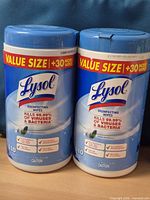 Front view of two Lysol disinfecting wipes canisters showing English label, value size banner and 110 count