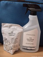 Front view of both products: spray bottle and pouch