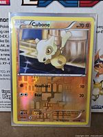 Front of Cubone reverse holo card showing artwork, foil, moves and card number