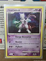 Front of Mewtwo holographic card showing artwork, holo pattern, set info 9/100