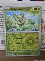 Front of Sprigatito reverse holo card in sleeve