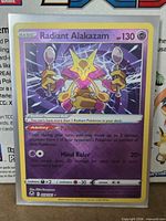 Front of sleeved Radiant Alakazam card showing holographic foil and set details