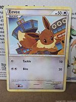 Front of Eevee 67/90 card showing artwork, HP, attacks