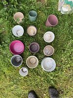 All 13 ceramic pots arranged on grass