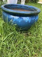 Blue ceramic planter side view showing shape and glaze