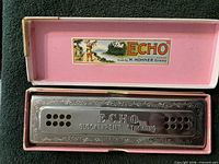 Hohner Echo harmonica in open pink box showing brand label