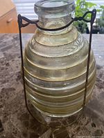 Full view of glass insect trap in wire hanger