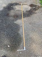 Full view of wooden log rule laid out on ground