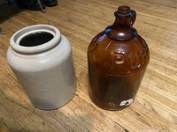 Stoneware crock and amber Purex jug side by side