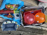 Tote with tubes, grey bin with exercise balls, cage parts, and fabric carrier bag