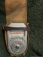 Meter in leather case front view showing dial and scale