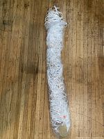 rolled white rope hammock with plastic wrap