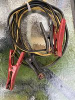 Overall view of jumper cables showing insulation color and all clamps