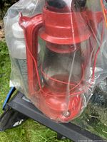 Red lantern in plastic bag next to bottle