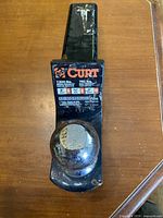 Front view showing Curt label, weight ratings, hitch ball