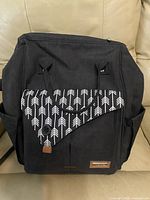 Front view showing overall style, arrow flap, pockets, brand patch