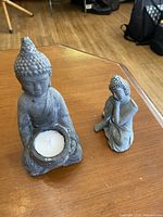 Both Buddha figurines on tabletop