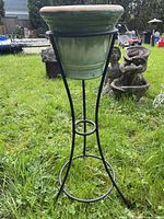 Full view of metal stand with planter outdoors