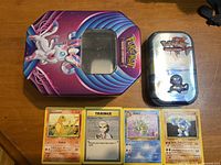 Overview of both tins and four cards