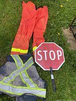 Vest, pants, and STOP side of sign on grass