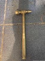 Overall view of brass hammer showing dual faces