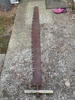 Full view of entire crosscut saw blade and handle