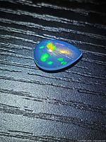 Front view of pear cabochon opal showing play-of-color