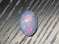 Front view of oval opal showing multicolor play of color