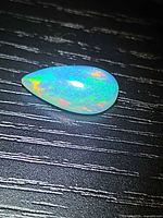 Pear cabochon opal showing play of color