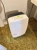 Front view of Garrison dehumidifier standing on floor