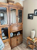 Full view of cabinet showing glass doors, drop-front desk and cane panel doors