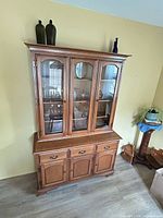Full view of china cabinet showing glass doors, drawers, lower doors