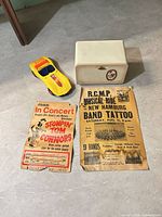 Group shot showing toy car, posters and container
